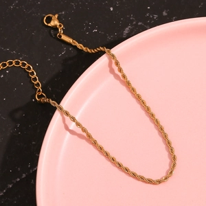 Detail of 2mm twisted rope chain anklet in 18K gold finish with lobster clasp closure