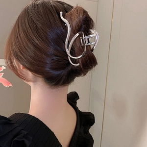 Silver irregular geometric metal hair claw clip worn on hair with minimalist aesthetic