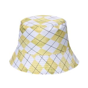 Detailed view of yellow and white checkerboard pattern on the sun protection bucket hat