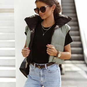 Detail of light green hooded vest showing contrasting black lining and stand collar