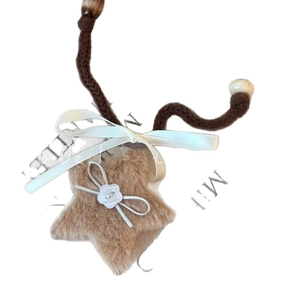 Vintage star pendant necklace with plush brown star and beige ribbon bow for winter style