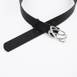 Close-up of black leather belt with a minimalist silver geometric buckle detail