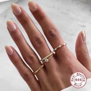 Close-up of S925 sterling silver V-shaped rings with opal and diamonds on a model hand