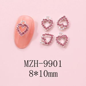 Macro detail of hollow heart nail art charm with pink rhinestone, 8x10mm silver metal base