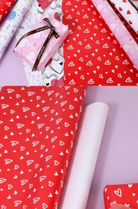 Detail showing red and white heart gift wrap paper with a ribbon tied gift box