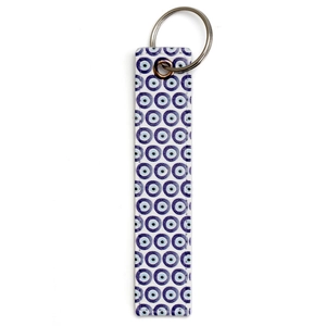 Detailed close-up of blue evil eye charm strap with a silver metal keychain ring
