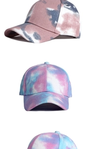 Detailed close-up of multi-color tie-dye cotton baseball caps in various vibrant patterns