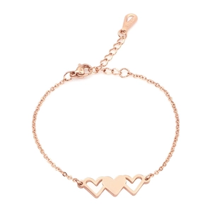 Detail of rose gold triple heart bracelet showing 18KGP engraving on polished metal