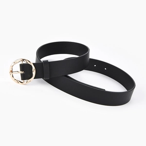 Women's black faux leather belt with a round golden buckle and textured finish