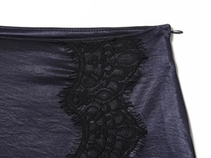Detail view of smooth purple satin fabric with intricate black lace trim and hidden zipper