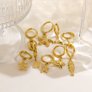 Detail of 14K gold plated starfish shell and whale tail charms on nautical hoop earrings