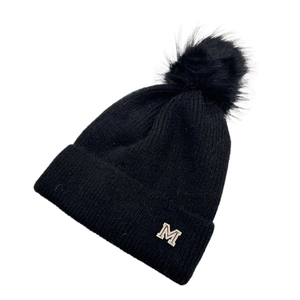Dettaglio del berretto nero in maglia con pompon sintetico e lettera M in cristallo