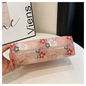 Detail shot of the bottom floral embroidery on this elegant pink qipao evening bag
