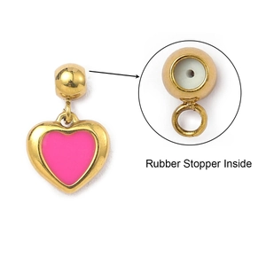 Detail of pink heart charm showing internal rubber stopper and gold-tone loop