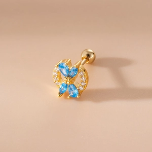 Detailed shot of golden butterfly stud earring with blue marquise stones and zircons