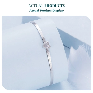 Close-up of heart-shaped zircon on S925 sterling silver herringbone snake chain bracelet