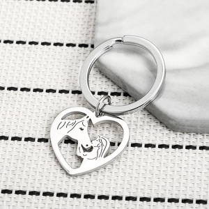 Polished silver stainless steel heart keychain with horse and girl silhouette design