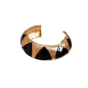 Vintage gold open bangle with black enamel triangles and textured vertical stripes