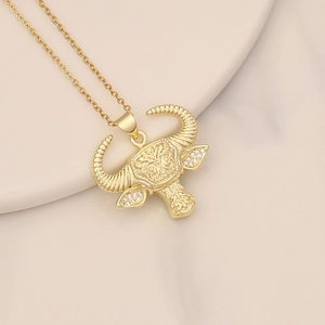 Golden bull head necklace with micro-pave zircons on a soft gradient background