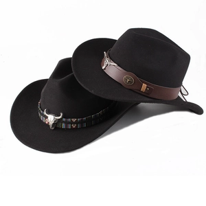 Detail of black felt cowboy hats with cattle head metal charms and decorative hat bands