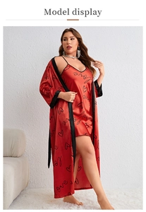 Detail view of plus size red satin sleepwear set with heart patterns and black lace trim
