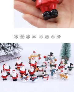 Macro shot of miniature resin Santa and snowman figurines for festive holiday decor