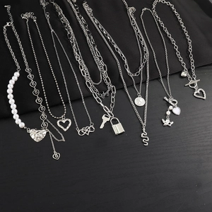 Detailed collection of silver-tone necklaces with butterfly, heart, and pearl charms