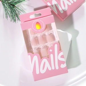 Pink and white gradient French press-on nails set in elegant packaging on stone base