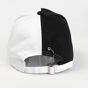 Detail of bicolored baseball cap featuring metal ring accent and adjustable rear buckle