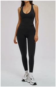 Detail shot of black deep V-neck halter sports bra and high-waisted yoga leggings