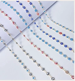 Detailed macro view of colorful Evil Eye charm chains for DIY jewelry making