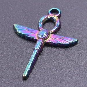 Macro detail of rainbow stainless steel Ankh dragonfly pendant with iridescent finish