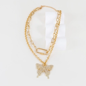 Double-layered gold chain necklace featuring a large sparkling butterfly pendant with rhinestones