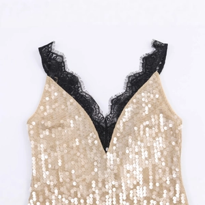 Fashionable champagne gold sequin dress featuring a black lace trim and deep V-neckline