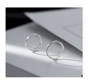 Detail of S925 sterling silver wave ring engraved with smooth waters run deep text