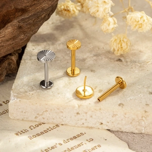 Titanium G23 sunburst flat back labret studs in silver and gold set on stone