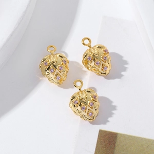 Close-up detail of three 18K gold plated fruit charms with pink cubic zirconia