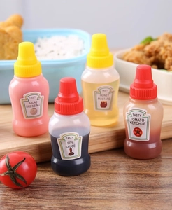 Detailed view of four portable mini sauce bottles on a tray for lunch bento seasoning