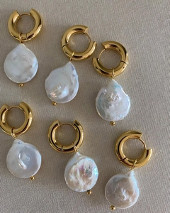 Baroque irregular pearl drop earrings with gold hoops on textured grey fabric