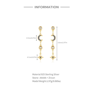 Detail of 925 sterling silver star and moon earrings with blue zircon in gold finish