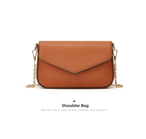 Detail showing brown Saffiano leather texture and gold chain strap of the shoulder bag