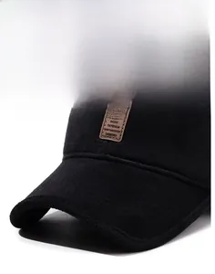 Close-up of a black winter baseball cap with a sport leather patch and rigid brim detail