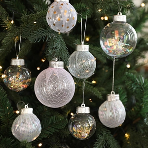 Christmas tree ornaments set with glitter and mesh hanging on branches with warm lights