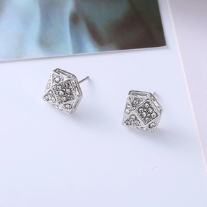 Macro view of geometric diamond-shaped stud earrings with sparkling white cubic zirconia