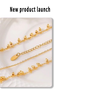 Detailed macro view of 18k gold plated copper necklace with spherical beads and tassel detail