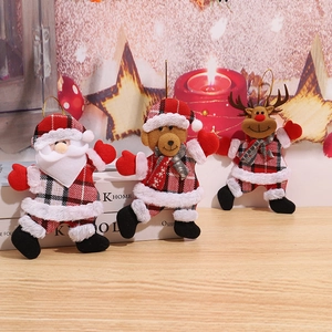 Three plush Christmas hanging ornaments featuring Santa, bear, and reindeer on wood surface