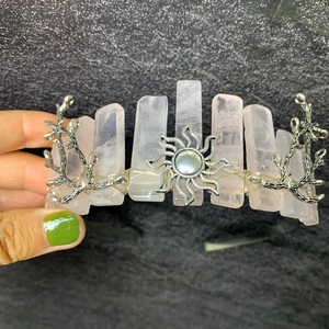 Detail of pink crystal crown with silver wire weaving and sun motif decoration