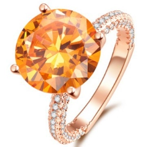 Elegant rose gold ring with a large orange gemstone and micro-pave white zircon stones