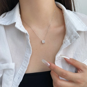 Macro shot of S925 silver necklace with sparkling square zircon worn on neck
