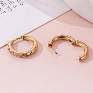 Detailed close-up of gold plated huggie earrings featuring micro-paved zircon crystals